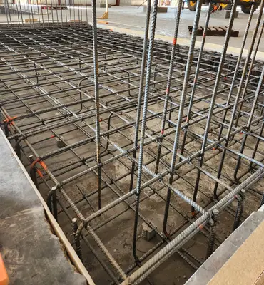 A civil crew placing concrete foundations on a construction site
