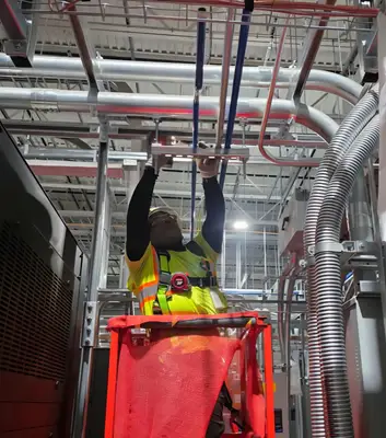 An industrial electrician terminating gear during a plant shutdown