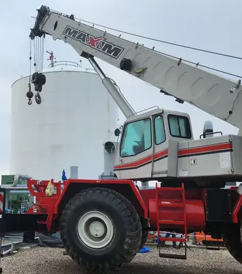 A crane operator executing a lift on a heavy-equipment jobsite
