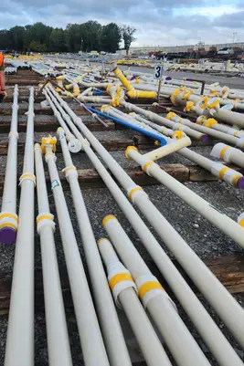 A pipefitter assembling process piping at an industrial plant